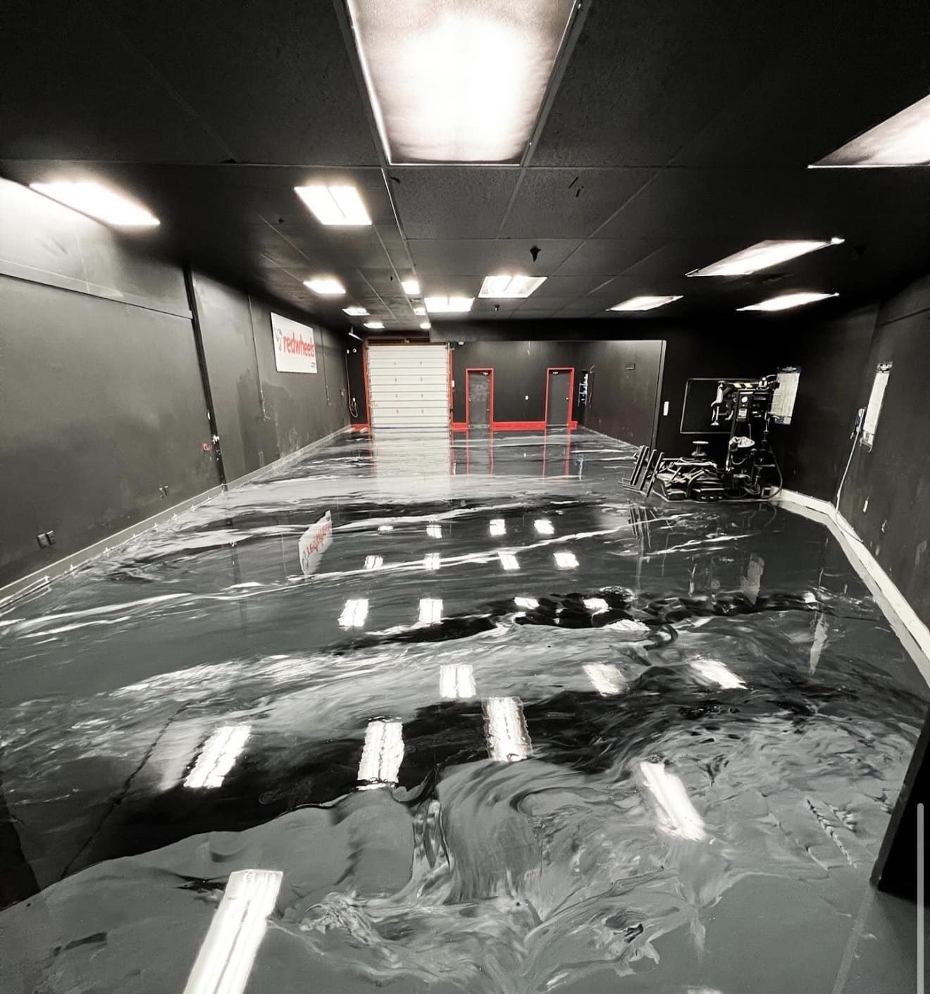 Black metallic epoxy floor in a commercial shop by Titan Floor Systems, GTA